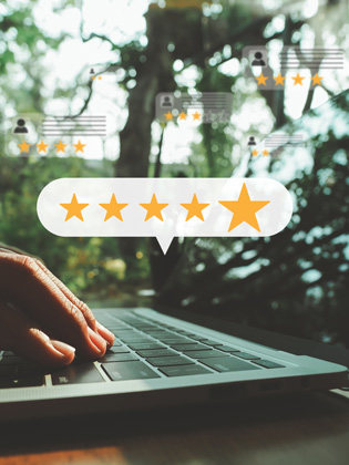 Person on laptop leaving a 5 Wells Trust Google review