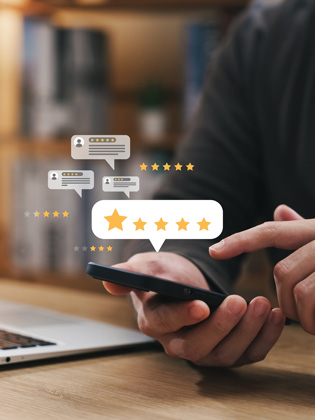 Person holding phone while leaving a 5 Wells Trust Google review